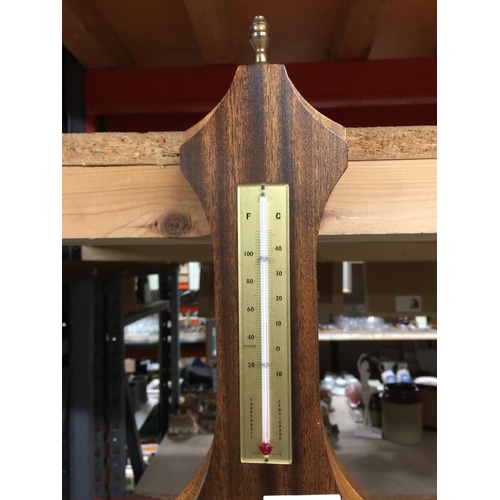 1068 - A BAROMETER IN A WOODEN FRAME