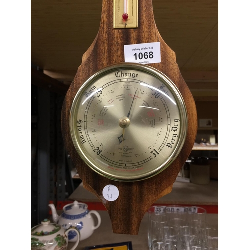 1068 - A BAROMETER IN A WOODEN FRAME