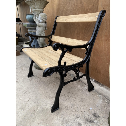 1534 - A WOODEN SLATTED WIDE GARDEN CHAIR WITH CAST IRON ENDS