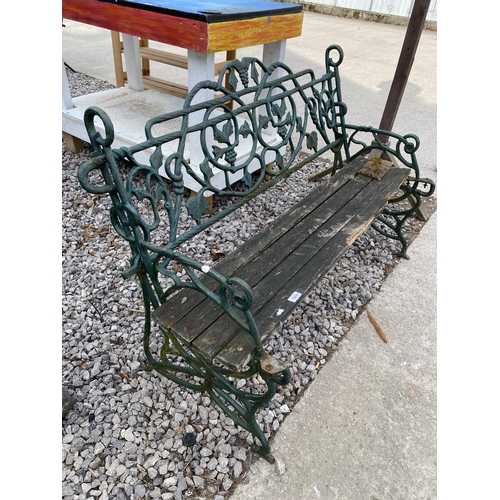 1974 - A DECORATIVE CAST IRON GARDEN BENCH WITH WOODEN SLATTED SEAT