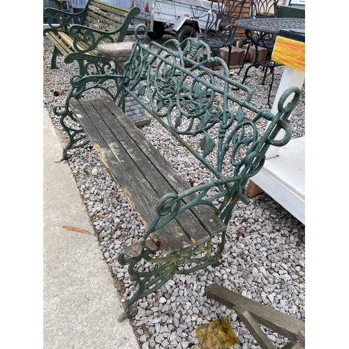 1974 - A DECORATIVE CAST IRON GARDEN BENCH WITH WOODEN SLATTED SEAT