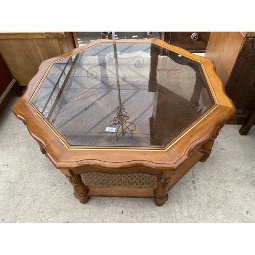 2588 - A MODERN OCTAGONAL COFFEE TABLE WITH GLASS TOP AND CANE UNDERTIER, 42