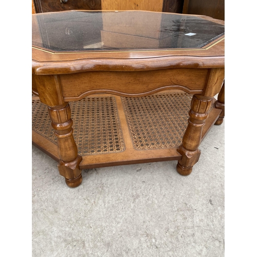 2588 - A MODERN OCTAGONAL COFFEE TABLE WITH GLASS TOP AND CANE UNDERTIER, 42