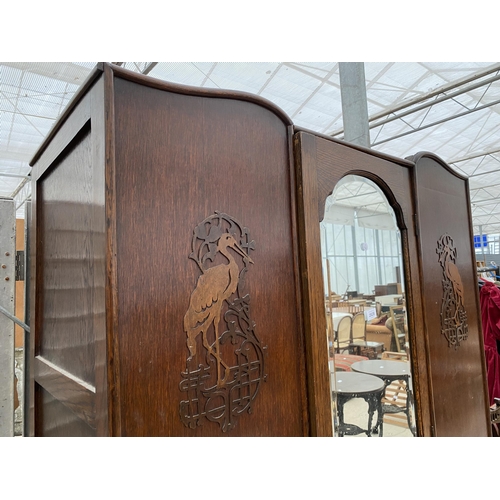 2828 - AN EARLY 20TH CENTURY OAK MIRROR-DOOR WARDROBE WITH DRAWER TO THE BASE AND APPLIED FLAMINGO DECORATI... 