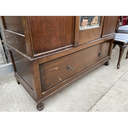 2828 - AN EARLY 20TH CENTURY OAK MIRROR-DOOR WARDROBE WITH DRAWER TO THE BASE AND APPLIED FLAMINGO DECORATI... 