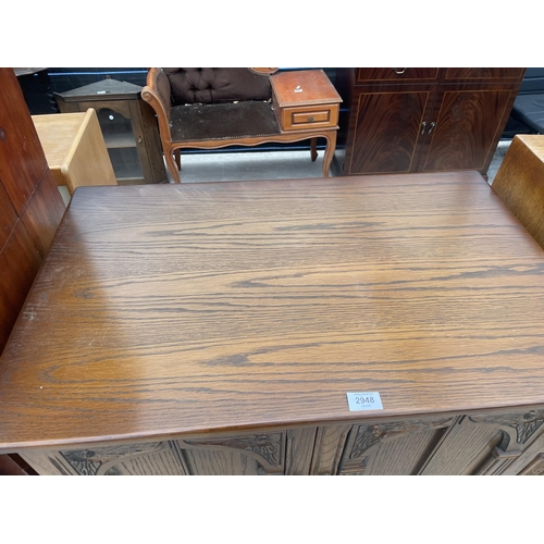 2948 - AN ANTIQUE STYLE OAK TV CABINET, 31