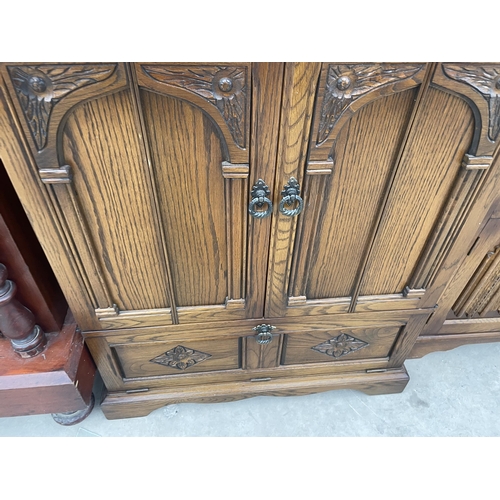 2948 - AN ANTIQUE STYLE OAK TV CABINET, 31