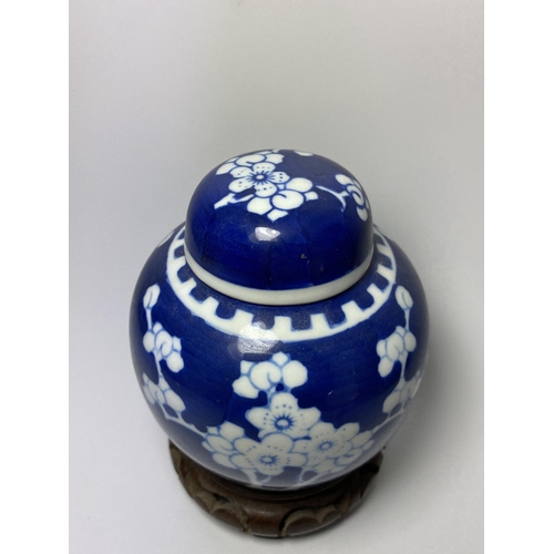 306 - A CHINESE PRUNUS BLOSSOM PATTERN GINGER JAR ON CARVED WOODEN STAND, DOUBLE RING MARK TO BASE, HEIGHT... 