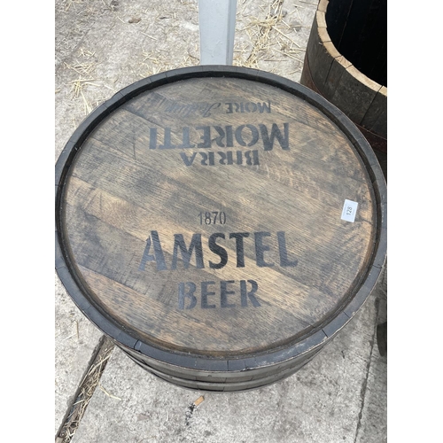 128 - A TABLE MADE FROM AN OAK BARREL MARKED WITH AMSTEL AND BIRRA MORETTI  - NO VAT