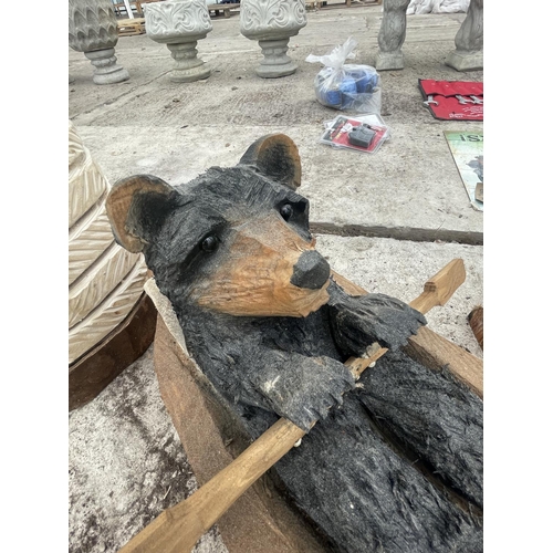 222 - A WOOD CARVING OF A BEAR IN A ROWING BOAT LENGTH APPROXIMATELY 60 CM NO VAT