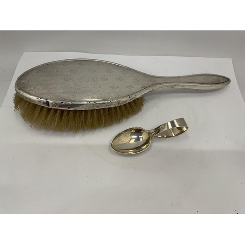 24 - A HALLMARKED SILVER BABY'S SPOON AND SILVER BACKED BRUSH