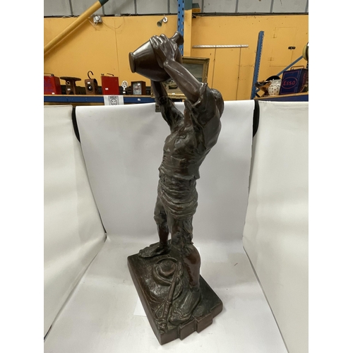 32 - A LARGE BRONZE MODEL OF A MAN DRINKING FROM A VESSEL, HEIGHT 74CM