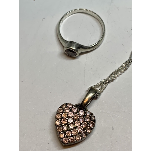 693 - A SILVER RING WITH PINK STONE AND A MATCHING HEART NECKLACE IN A BOX