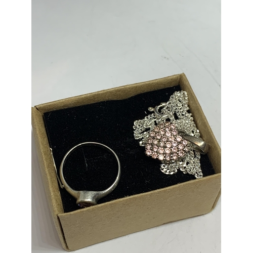 693 - A SILVER RING WITH PINK STONE AND A MATCHING HEART NECKLACE IN A BOX