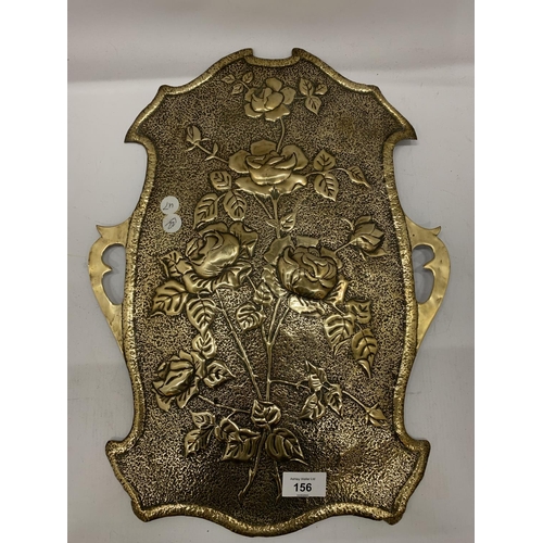 156 - A BRASS WALL HANGING IN THE SHAPE OF A SHIELD WITH FLORAL EMBOSSING 46CM X 34CM