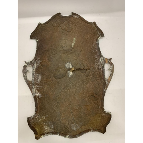 156 - A BRASS WALL HANGING IN THE SHAPE OF A SHIELD WITH FLORAL EMBOSSING 46CM X 34CM