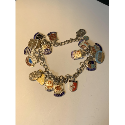 702 - A SILVER CHARM BRACELET WITH EIGHTEEN CITY AND PLACES CHARMS