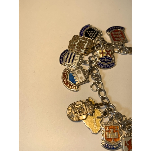 702 - A SILVER CHARM BRACELET WITH EIGHTEEN CITY AND PLACES CHARMS