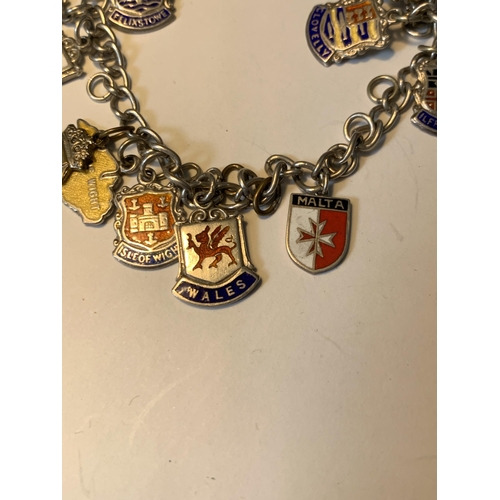 702 - A SILVER CHARM BRACELET WITH EIGHTEEN CITY AND PLACES CHARMS