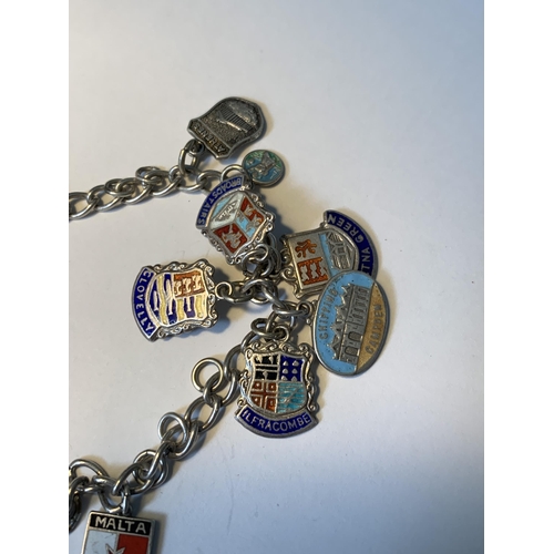 702 - A SILVER CHARM BRACELET WITH EIGHTEEN CITY AND PLACES CHARMS