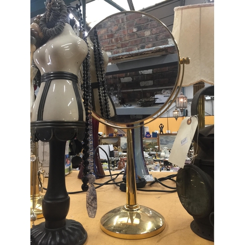 1196 - TWO BRASS TOILET MIRRORS, A WOOD AND CERAMIC JEWELLERY STAND PLUS A QUANTITY OF COSTUME JEWELLERY