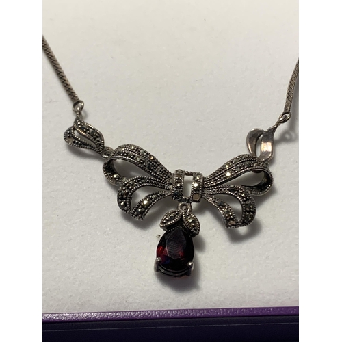 545 - A SILVER AND MARCASITE NECKLACE WITH RED STONE IN  A PRESNTATION BOX