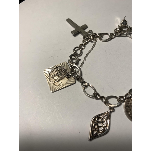 548 - A SILVER CHARM BRACELET WITH EIGHT CHARMS