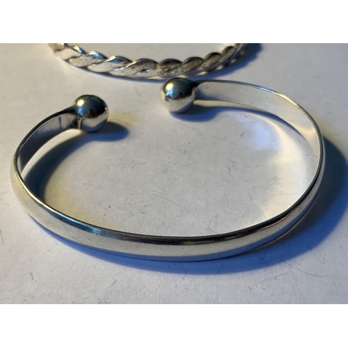 604 - TWO SILVER BANGLES