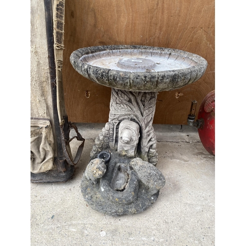 1638 - A RECONSTITUTED STONE BIRDBATH WITH PEDESTAL BASE FEATURING ANIMALS AT A TROUGH