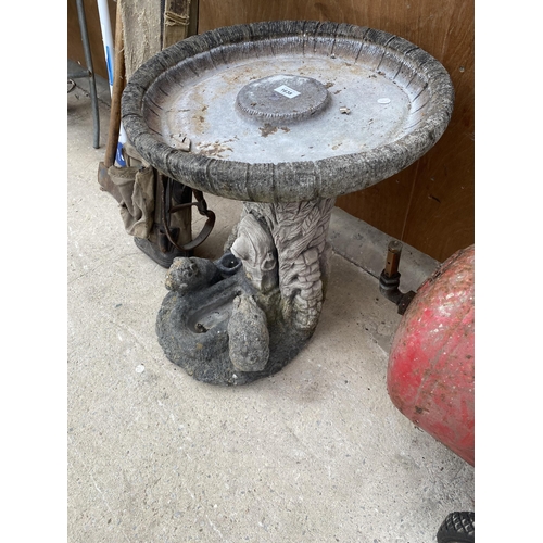 1638 - A RECONSTITUTED STONE BIRDBATH WITH PEDESTAL BASE FEATURING ANIMALS AT A TROUGH