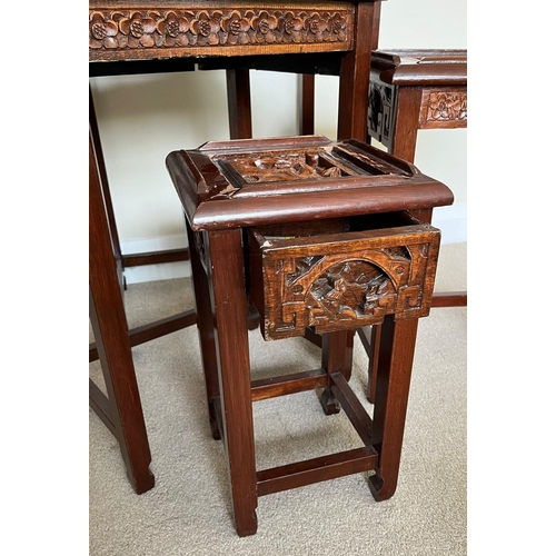 327 - A SET OF FOUR CHINESE CARVED HARDWOOD NEST OF TABLES, THE SMALLEST WITH SINGLE DRAWER