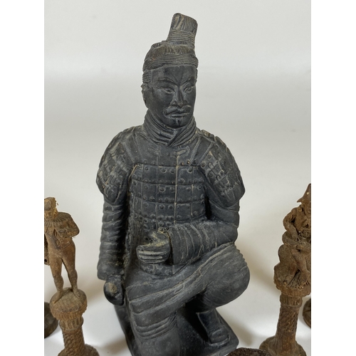 334 - A CHINESE XIAN POTTERY WARRIOR FIGURE TOGETHER WITH FIVE CARVED ORIENTAL CHESS PIECES & A CARVED OX ... 