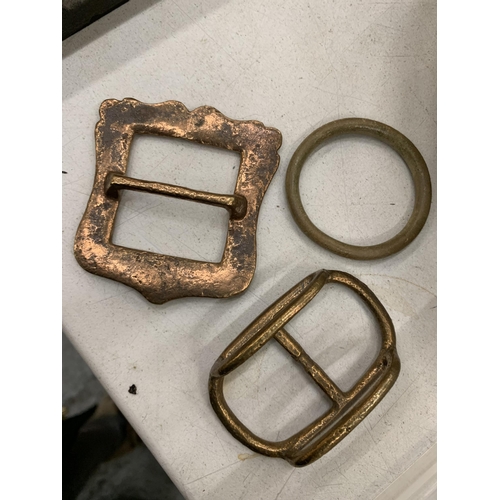 216 - A TUB OF BRASS BUCKLES