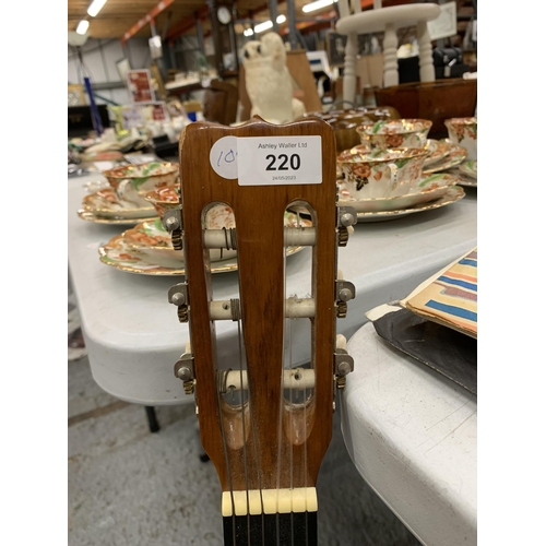 220 - A VINTAGE WOODEN ACOUSTIC GUITAR