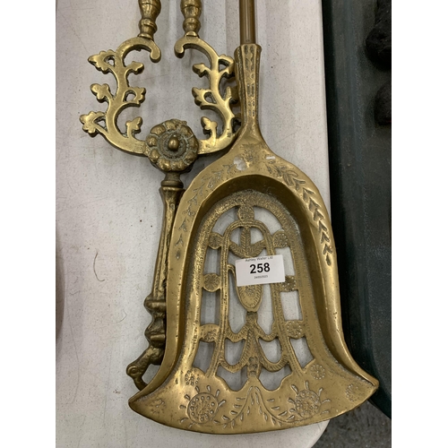 258 - A LARGE BRASS SHOVEL AND TONGS