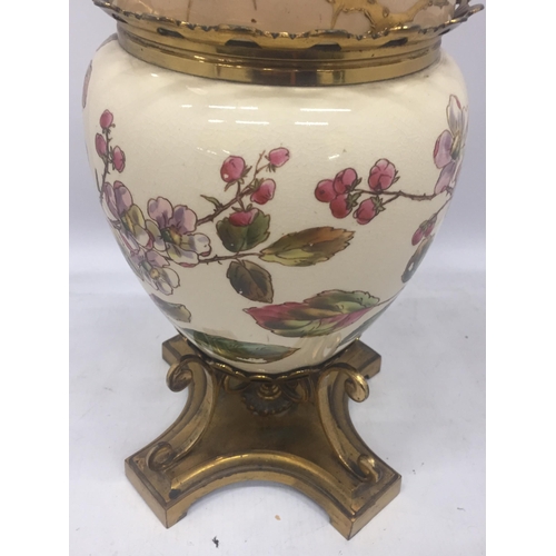 13 - AN ANTIQUE CERAMIC AND BRASS OIL LAMP WITH FLORAL DESIGN