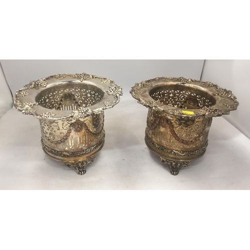 22 - A PAIR OF EARLY 20TH CENTURY WINE BOTTLE HOLDERS WITH FLORAL AND PIERCED DESIGN