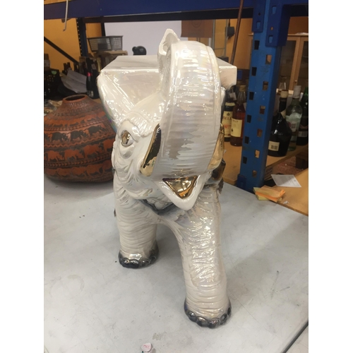 25 - A DECORATIVE CERAMIC GARDEN ELEPHANT SEAT WITH PEARLESCENT DESIGN AND GILT HIGHLIGHTS, HEIGHT 48CM