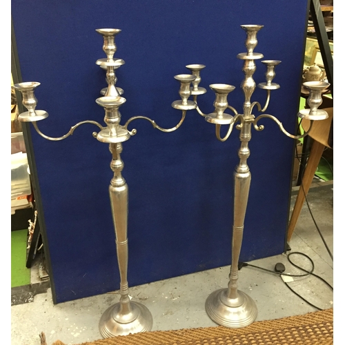 99 - A LARGE PAIR OF CHROME EFFECT FLOOR STANDING CANDLEABRA