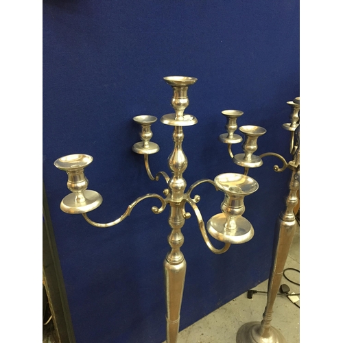 99 - A LARGE PAIR OF CHROME EFFECT FLOOR STANDING CANDLEABRA