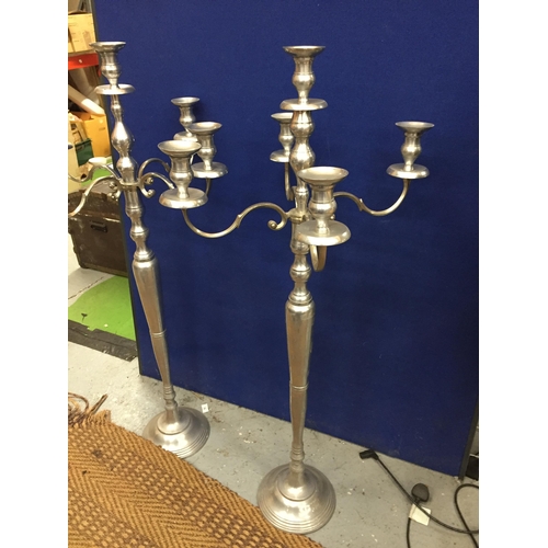 99 - A LARGE PAIR OF CHROME EFFECT FLOOR STANDING CANDLEABRA