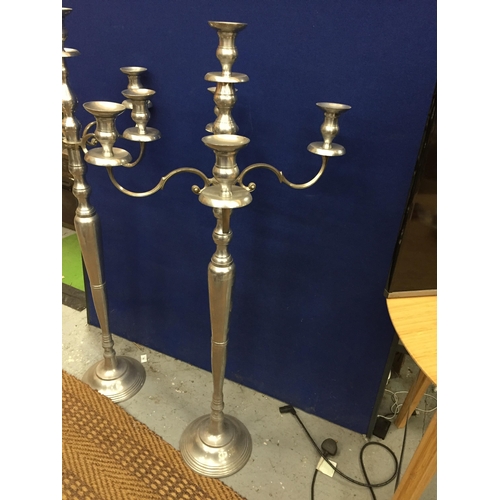 99 - A LARGE PAIR OF CHROME EFFECT FLOOR STANDING CANDLEABRA