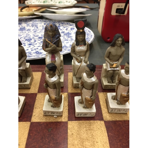 104 - A HEAVY VINTAGE CHESS BOARD COMPLETE WITH ROMANS AND EGYPTIANS CHESS PIECES