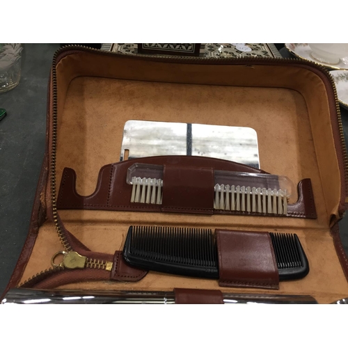 110 - A LEATHER CASED GENTLEMAN'S GROOMING KIT