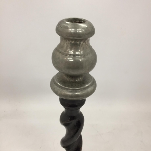 117 - AN ARTS AND CRAFTS PEWTER CANDLESTICK WITH BARLEY TWIST WOODEN STEM AND PEWTER TOP AND BASE