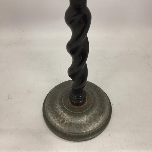 117 - AN ARTS AND CRAFTS PEWTER CANDLESTICK WITH BARLEY TWIST WOODEN STEM AND PEWTER TOP AND BASE