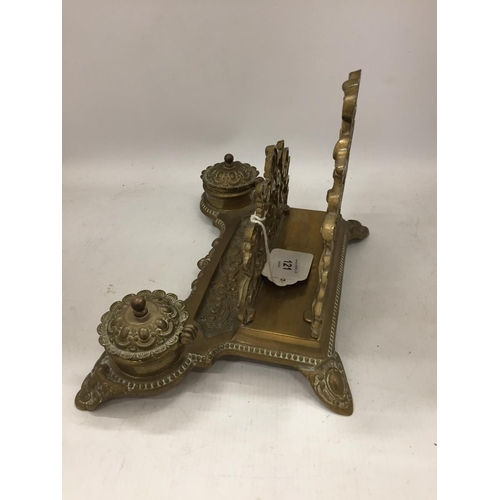 121 - A VINTAGE BRASS DESK SET INCLUDING INKWELLS AND A LETTER RACK