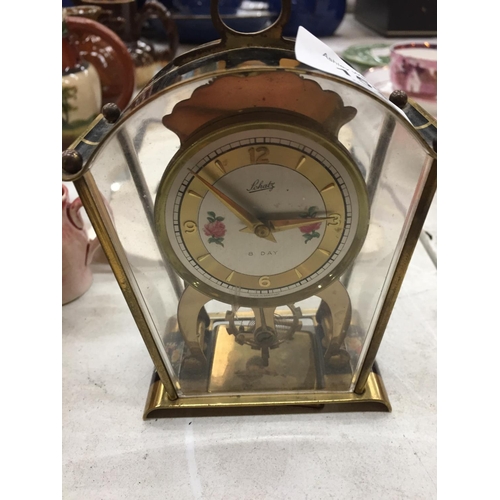 153 - A SMALL GERMAN MANTLE CLOCK WITH FLORAL PATTERN