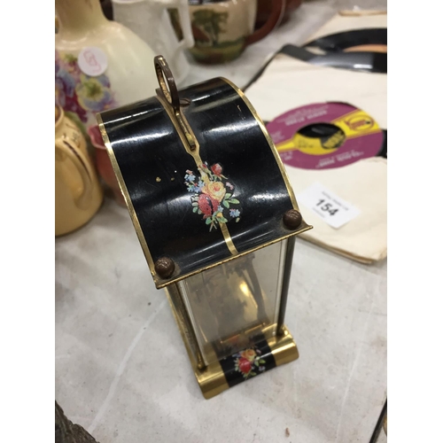 153 - A SMALL GERMAN MANTLE CLOCK WITH FLORAL PATTERN