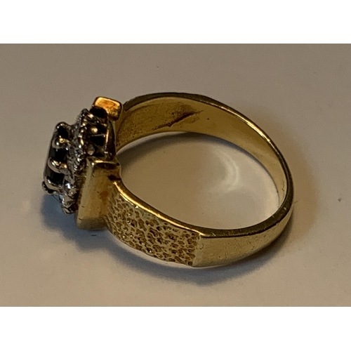 458 - AN 18 CARAT GOLD RING WITH A CENTRE SAPPHIRE SURROUNDED BY DIAMONDS SIZE J